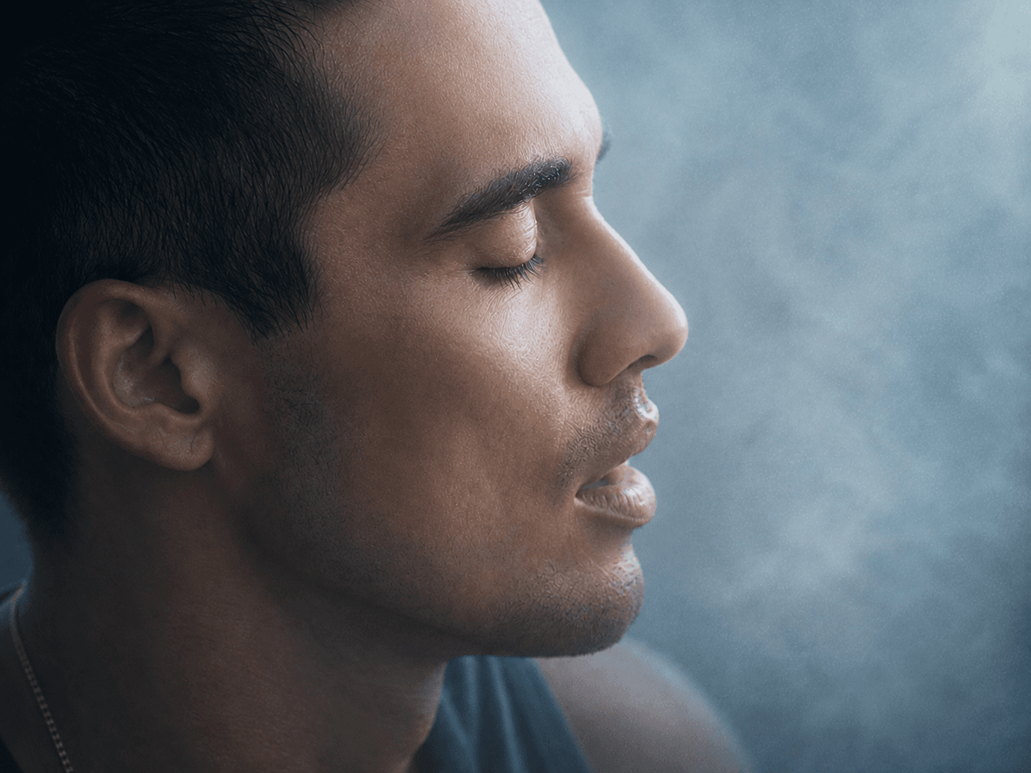 A man breathing calmly with eyes closed